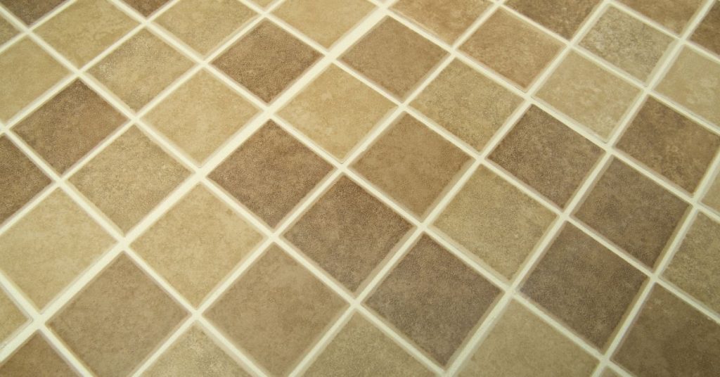 Close-up of a tile floor showcasing restored, clean grout lines