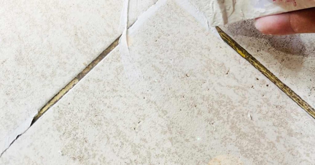 professional restoring antique tile floor with grout sealer