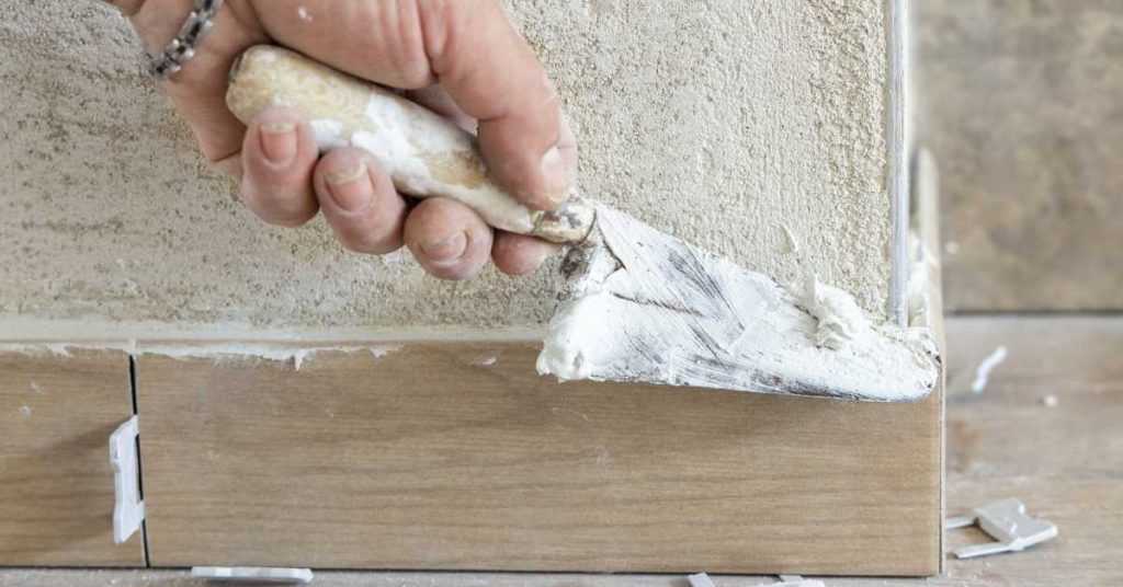 close‑up of freshly installed tile with grout lines being sealed using This Old Grout sealer